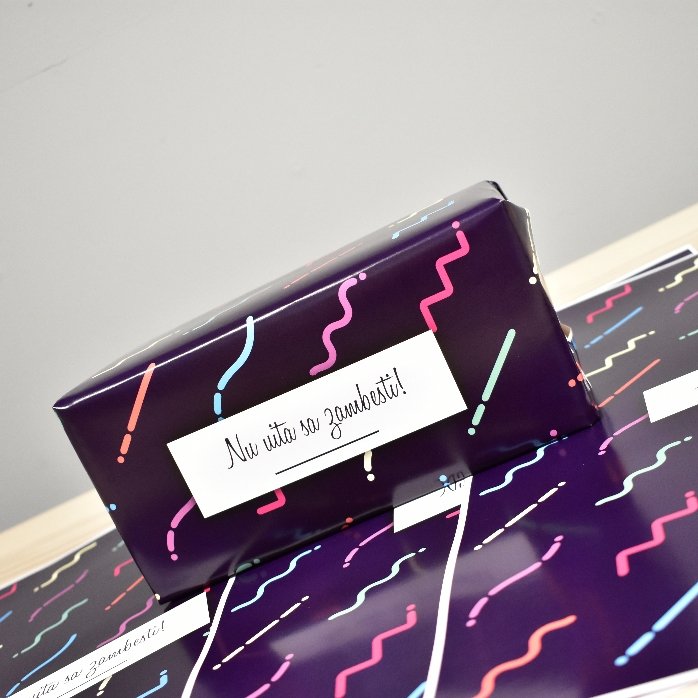 Personalised gift wrapping paper with text in a border, dark purple background