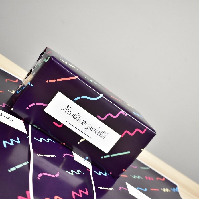 Personalised gift wrapping paper with text in a border, dark purple background