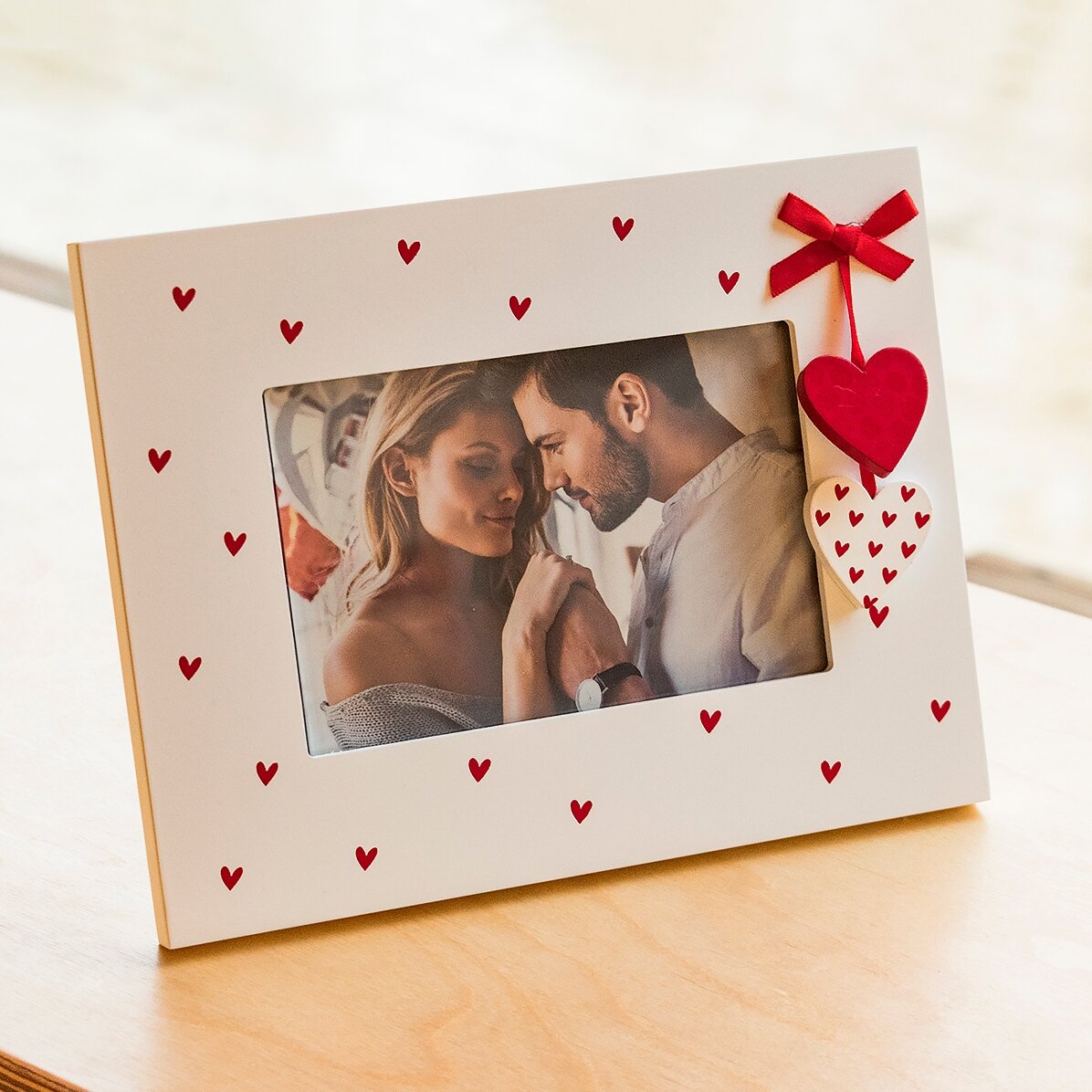 Desk photo frame with hearts and red bow with a photo